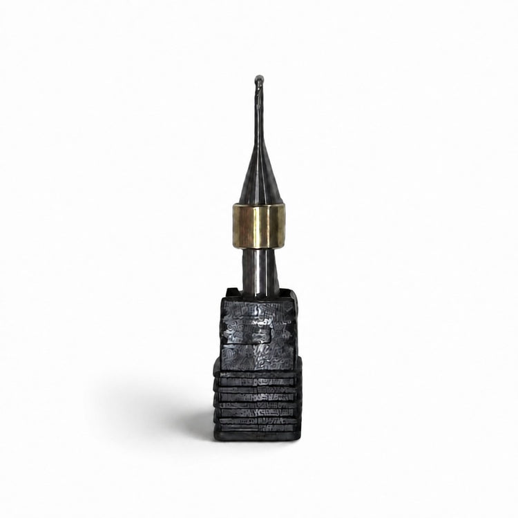 Aidite AMM-580 metal milling bur with black cutting head, brass collar, and silver shank on a white background.