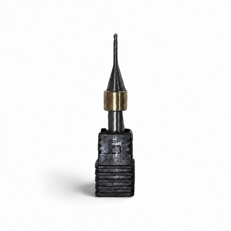 Aidite AMM-580 metal milling bur with black cutting head, brass collar, and silver shank on a white background.